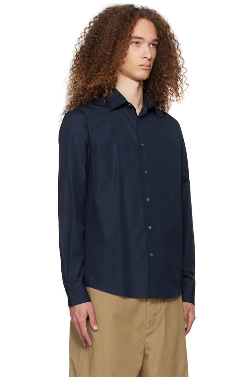 Sea Island cotton poplin shirt. 

· Spread collar
· Button closure
· Shirttail hem
· Single-button barrel cuffs
· Twin pleats at back yoke
· Shell hardware

Supplier color: Navy