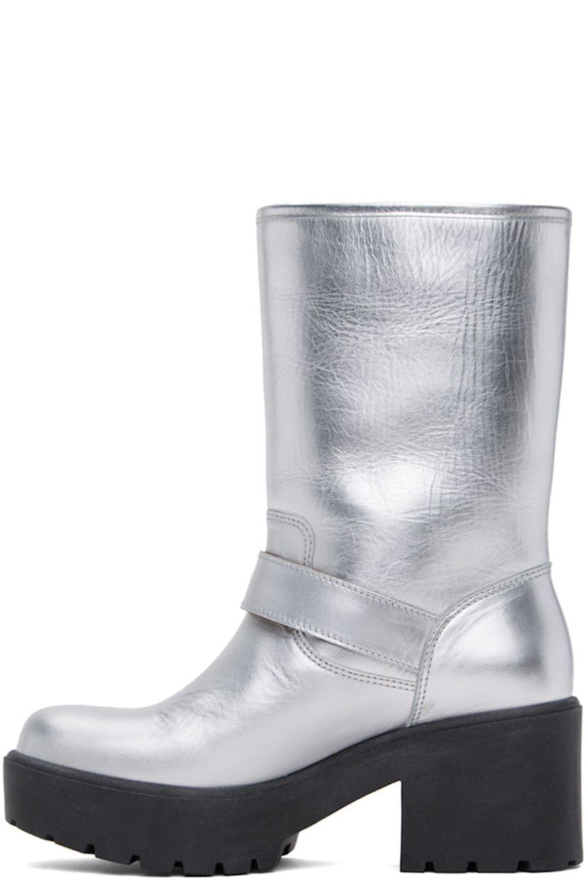 Calf-high grained leather boots in metallic silver tone.

· Pin-buckle strap at ankle and collar
· Logo hardware at outer side
· Buffed leather lining
· Foam rubber block heel
· Treaded foam rubber platform sole
· Platform: H1"
· Heel: H2.5"

Supplier color: Silver