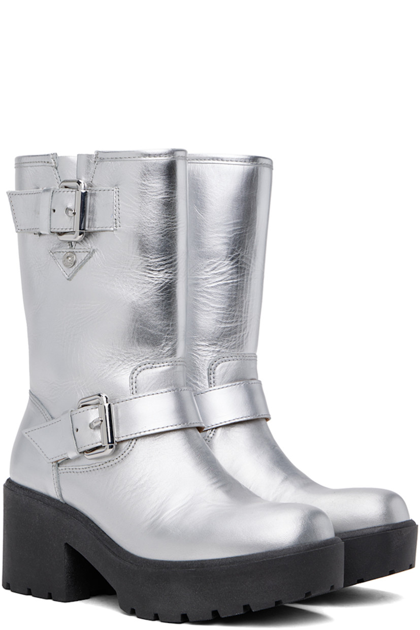 Calf-high grained leather boots in metallic silver tone.

· Pin-buckle strap at ankle and collar
· Logo hardware at outer side
· Buffed leather lining
· Foam rubber block heel
· Treaded foam rubber platform sole
· Platform: H1"
· Heel: H2.5"

Supplier color: Silver