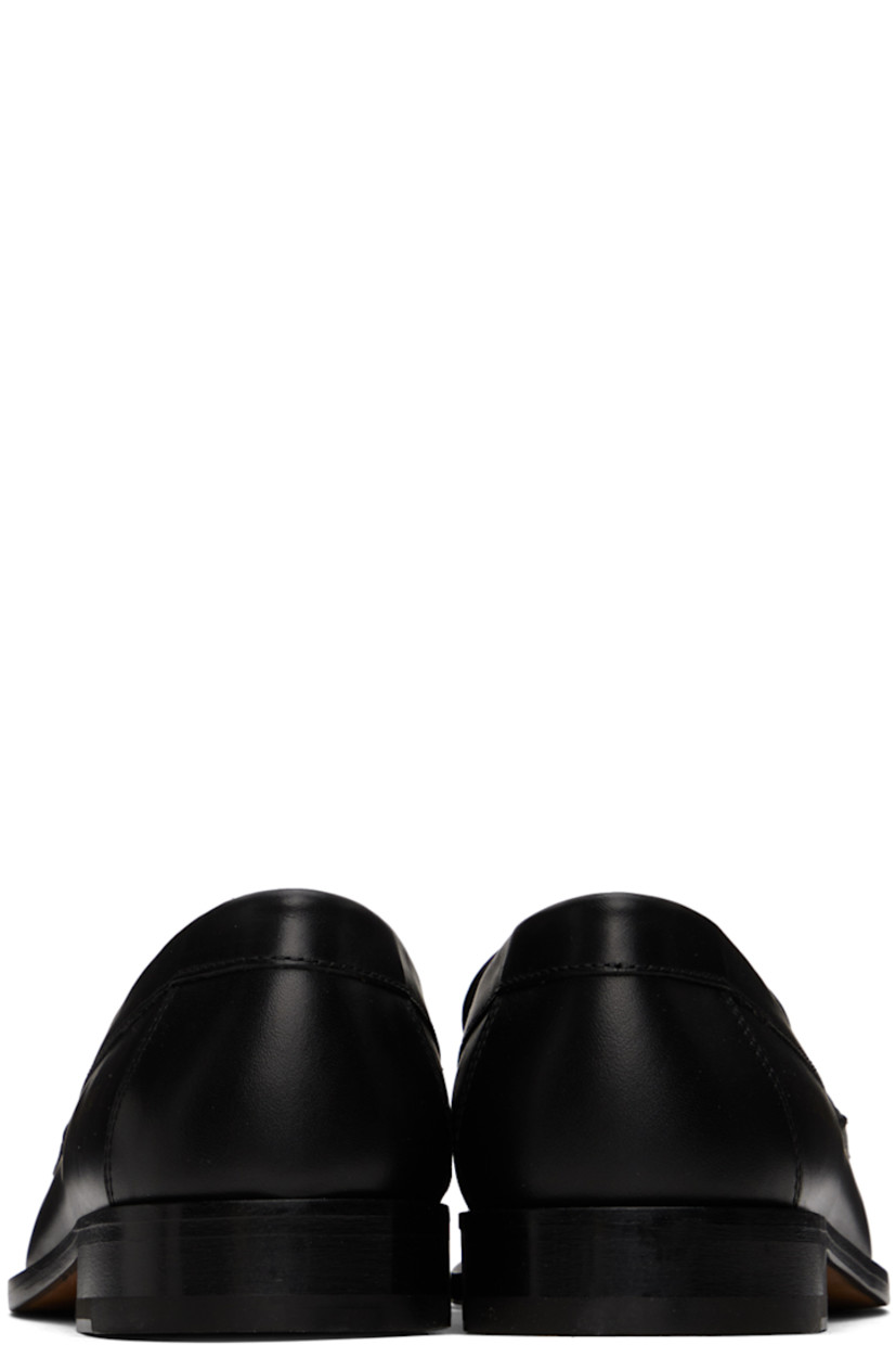 Buffed leather loafers in black.

· Moc toe
· Strap with cutout at vamp
· Signature series stamp at outer side
· Buffed leather lining
· Stacked leather block heel with rubber injection
· Leather sole

Supplier color: Black
