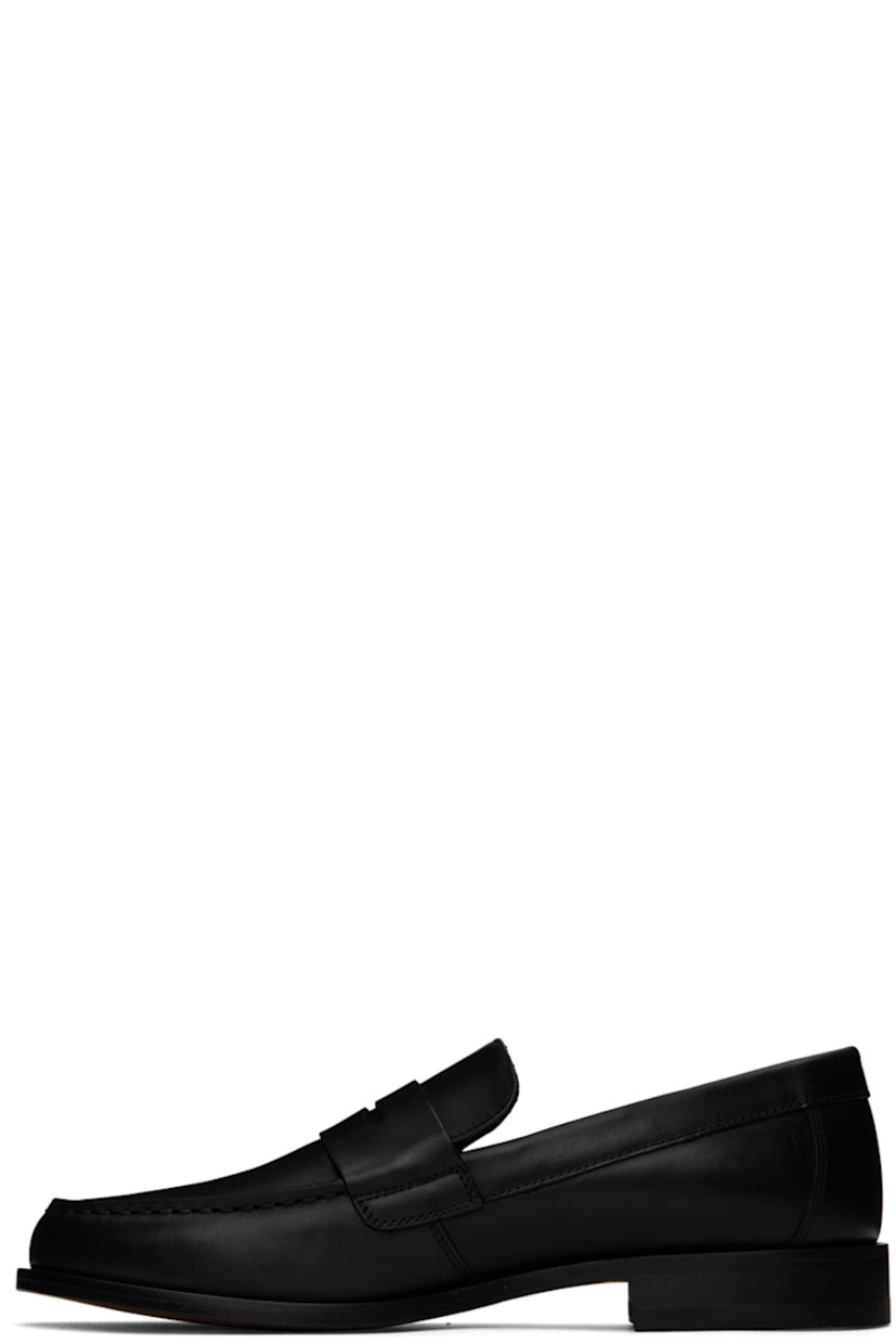Buffed leather loafers in black.

· Moc toe
· Strap with cutout at vamp
· Signature series stamp at outer side
· Buffed leather lining
· Stacked leather block heel with rubber injection
· Leather sole

Supplier color: Black
