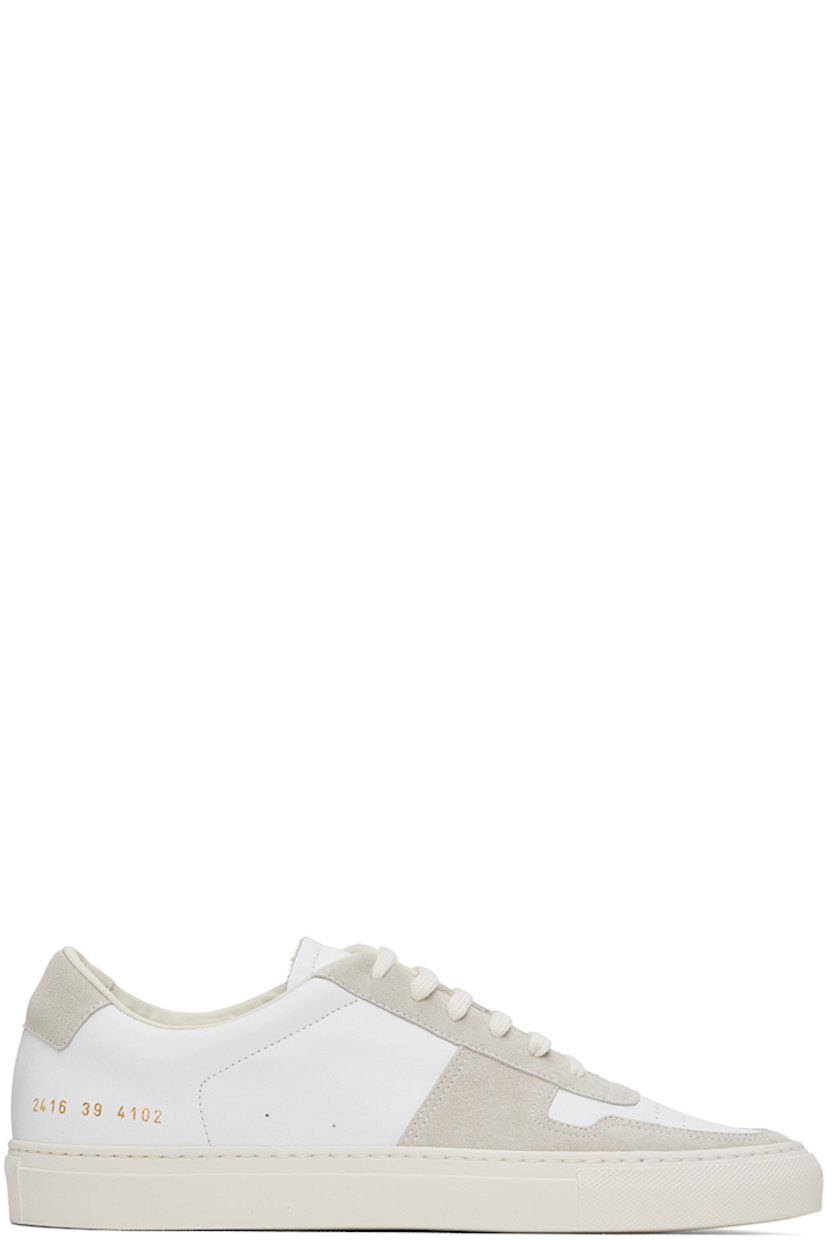 Low-top suede and grained leather sneakers in white and beige.

· Perforated detailing at toe and outer side
· Lace-up closure
· Padded tongue and collar
· Stitching at sides
· Signature series stamp at outer side
· Treaded rubber sole

Supplier color: Off white