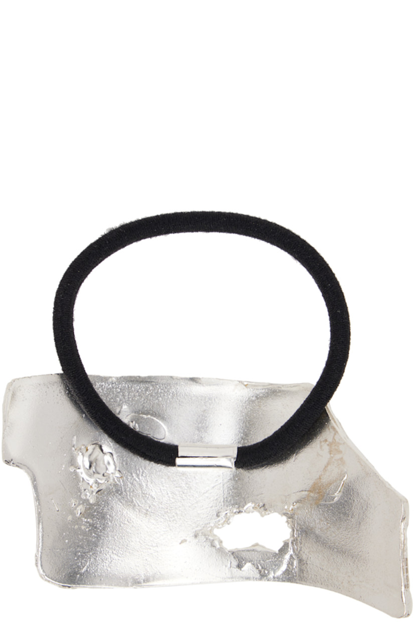 Elasticized hair tie in black. 

· Textured sterling silver hardware at face
· D2"

Supplier color: Silver