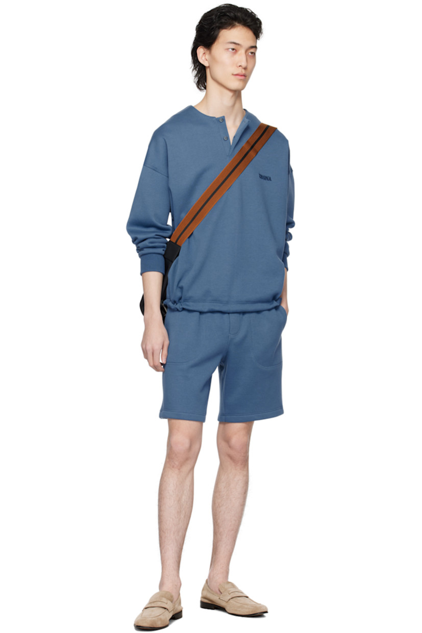 French terry shorts.

· Concealed drawstring at elasticized waistband
· Three-pocket styling
· Mock-fly
· Logo embroidered at front

Supplier color: Blue medio