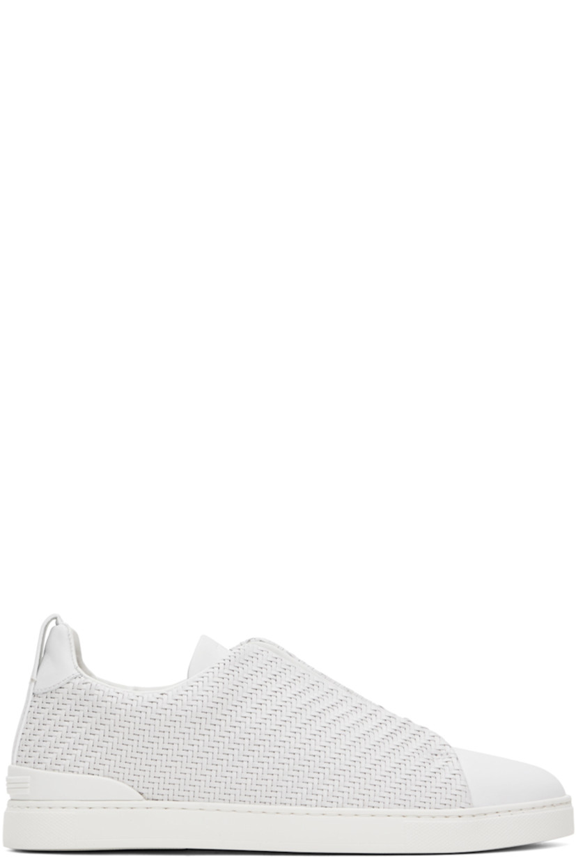 Low-top woven PELLETESSUTA™ buffed lambskin and calfskin slip-on sneakers in white.

· Strobel construction
· Elasticized criss-crossing straps at vamp
· Logo embossed at padded tongue
· Padded collar
· Pull-loop at heel collar
· Rubberized logo patch at heel counter
· Buffed leather lining
· Treaded rubber sole

Supplier color: White