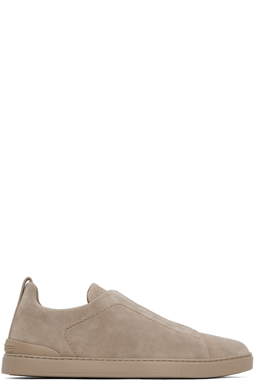 Low-top suede sneakers in taupe.

· Elasticized criss-crossing straps at vamp
· Logo embossed at padded tongue
· Concealed elasticized gussets at tongue
· Padded collar
· Pull-loop at heel tab
· Sanitized® footbed 
· Treaded rubber sole

Supplier color: Taupe