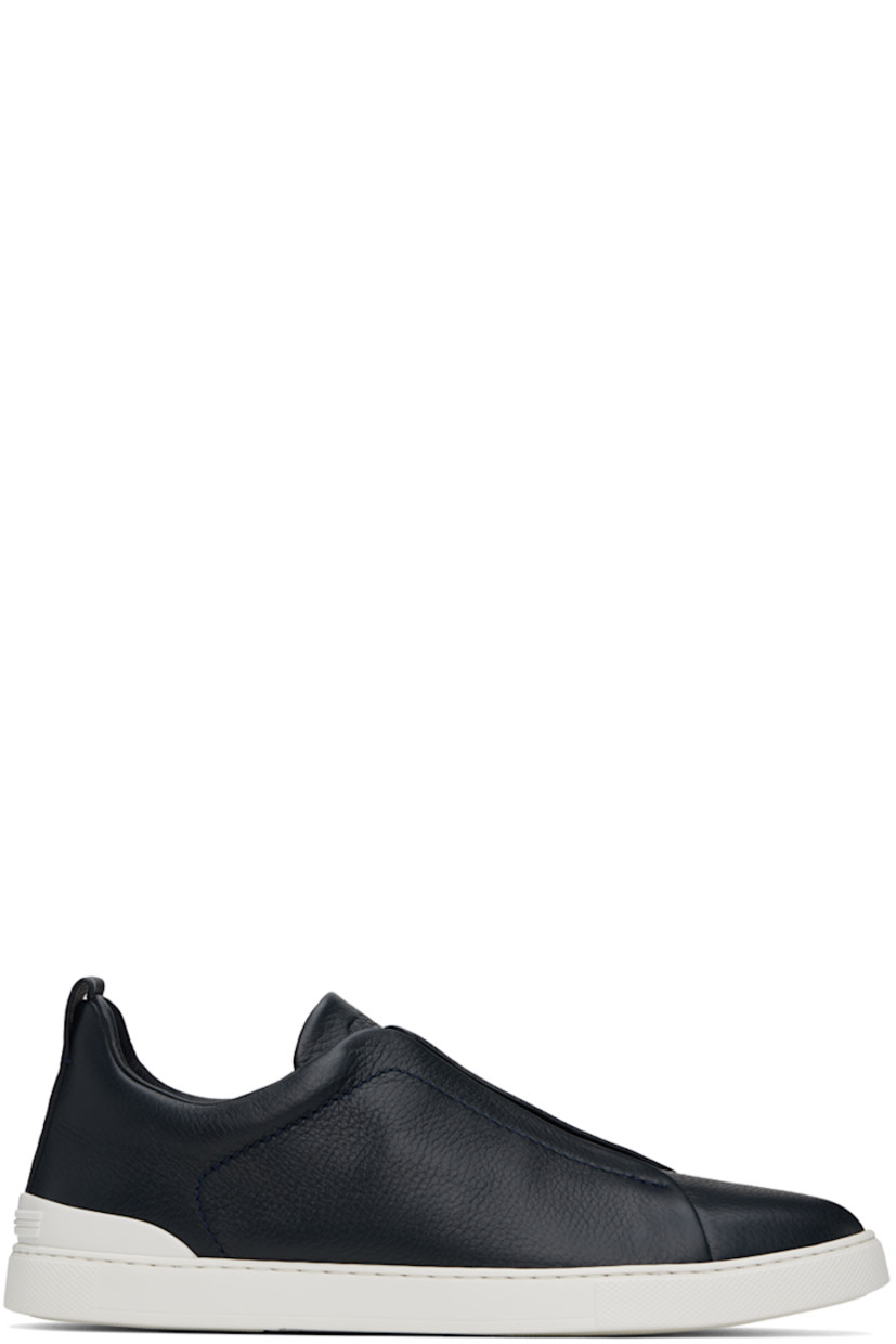 Low-top grained deerskin sneakers in navy.

· Elasticized criss-crossing straps at vamp
· Logo embossed at padded tongue
· Padded collar
· Pull-loop at heel tab
· Sanitized® insole
· Buffed leather lining
· Treaded rubber sole

Supplier color: Navy blue