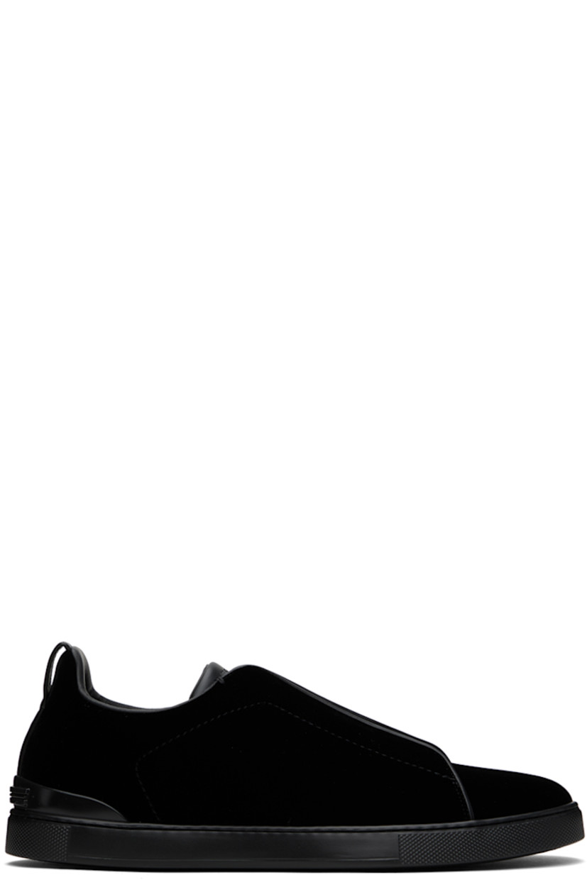 Low-top velvet slip-on sneakers in black.

· Buffed calfskin trim throughout
· Elasticized criss-crossing straps at vamp
· Logo embossed at padded tongue
· Padded collar
· Pull-loop at heel collar
· Rubberized logo patch at heel counter
· Cushioned Sanitized® insole
· Buffed leather lining
· Treaded rubber sole

Supplier color: Black