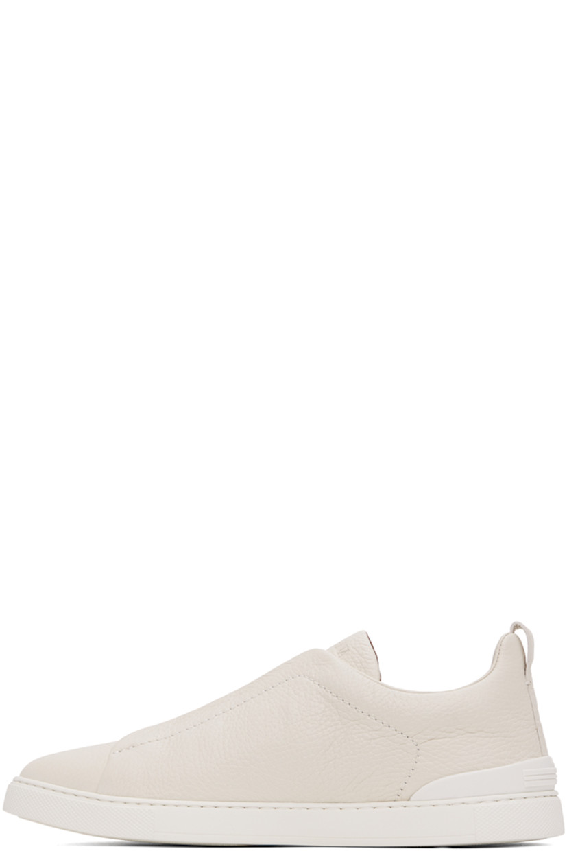 Low-top grained deerskin sneakers in off-white.

· Elasticized criss-crossing straps at vamp
· Logo embossed at padded tongue
· Concealed elasticized gussets at tongue
· Padded collar
· Pull-loop at heel tab
· Sanitized® footbed 
· Treaded rubber sole

Supplier color: Off-White