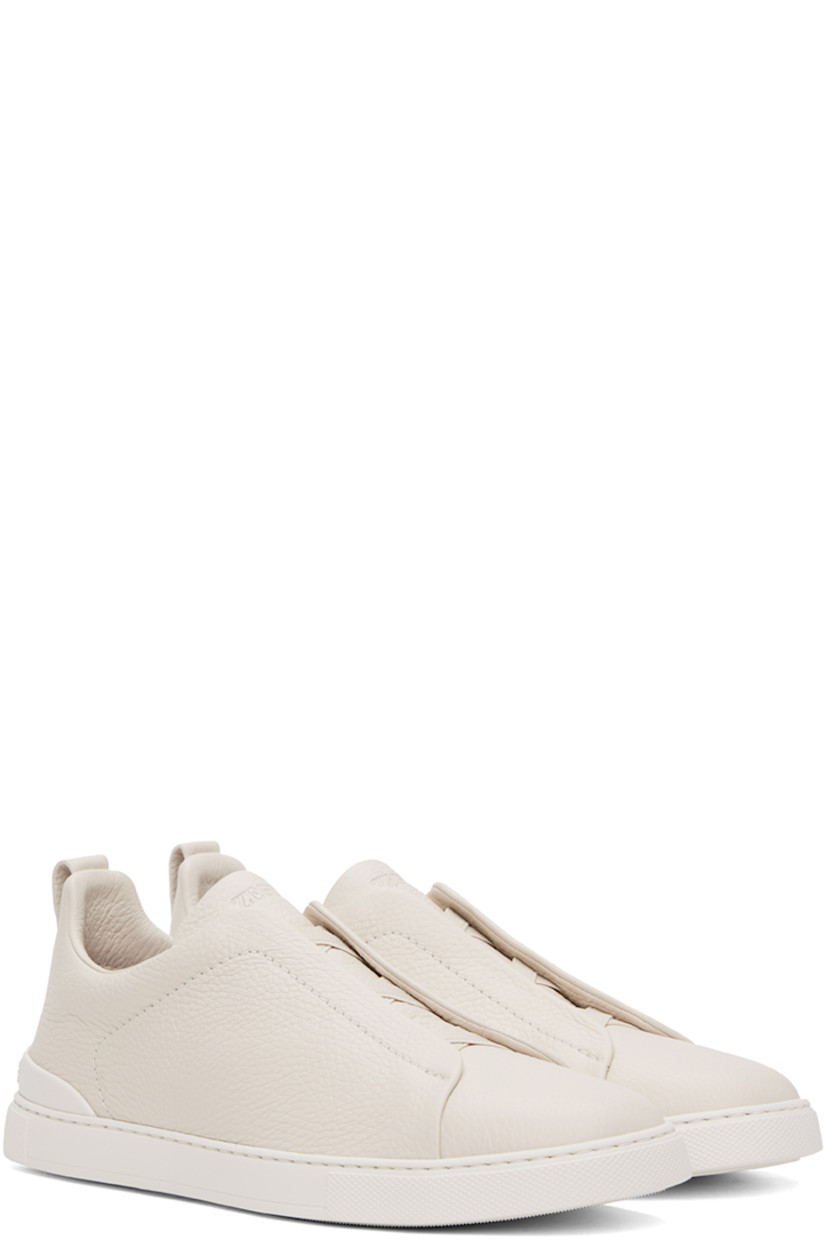 Low-top grained deerskin sneakers in off-white.

· Elasticized criss-crossing straps at vamp
· Logo embossed at padded tongue
· Concealed elasticized gussets at tongue
· Padded collar
· Pull-loop at heel tab
· Sanitized® footbed 
· Treaded rubber sole

Supplier color: Off-White