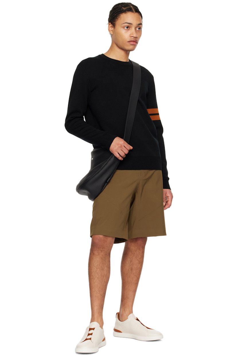 Low-top grained deerskin slip-on sneakers in off-white and tan.

· Elasticized criss-crossing straps at vamp
· Logo embossed at padded tongue
· Padded collar
· Pull-loop at heel collar
· Rubberized logo patch at heel counter
· Cushioned Sanitized® insole
· Buffed leather lining
· Treaded rubber sole

Supplier color: Off white