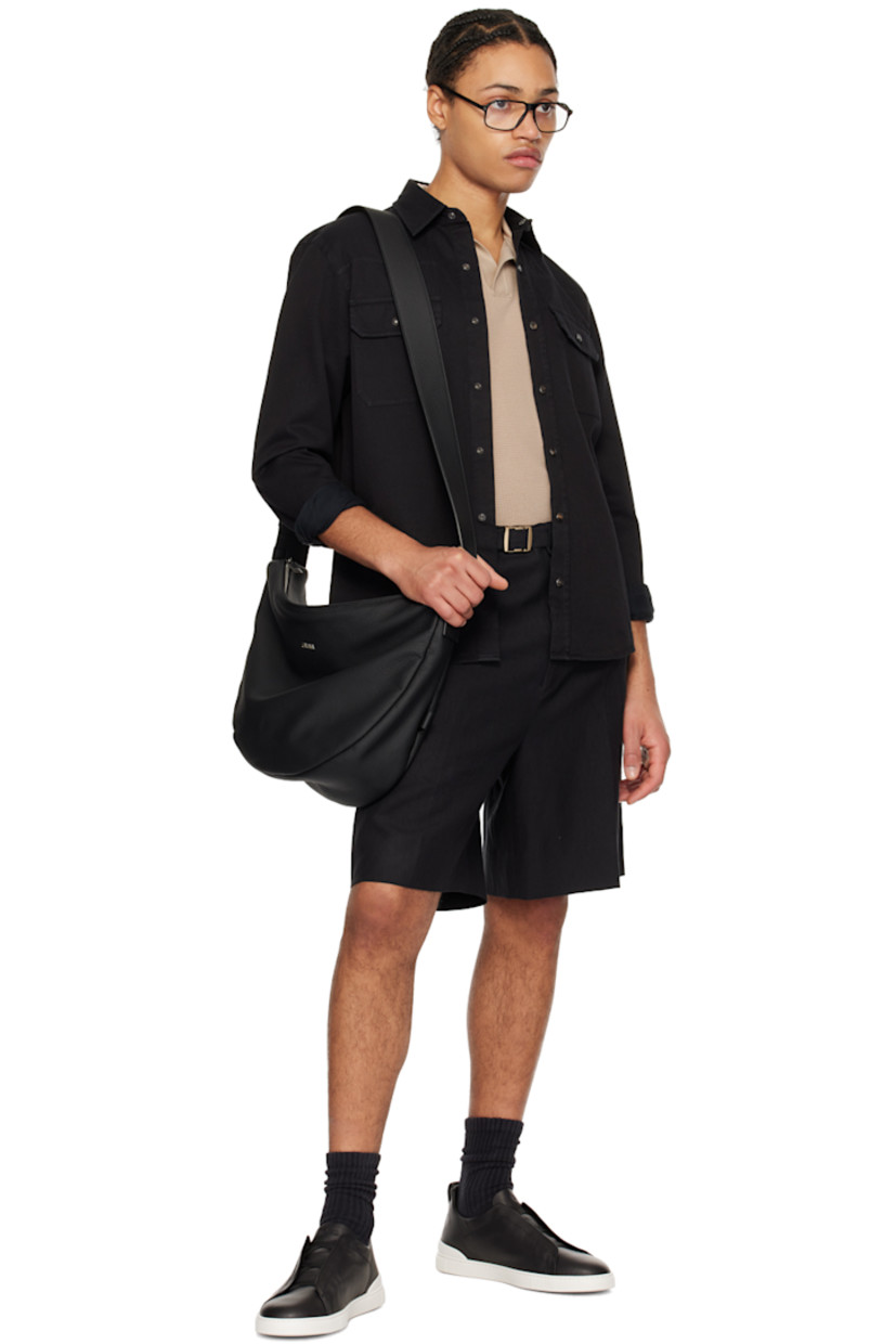 Low-top grained leather slip-on sneakers in black.

· Elasticized criss-crossing straps at vamp
· Logo embossed at padded tongue
· Padded collar
· Pull-loop at heel collar
· Rubberized logo patch at heel counter
· Cushioned Sanitized® insole
· Buffed leather lining
· Treaded rubber sole

Supplier color: Nero