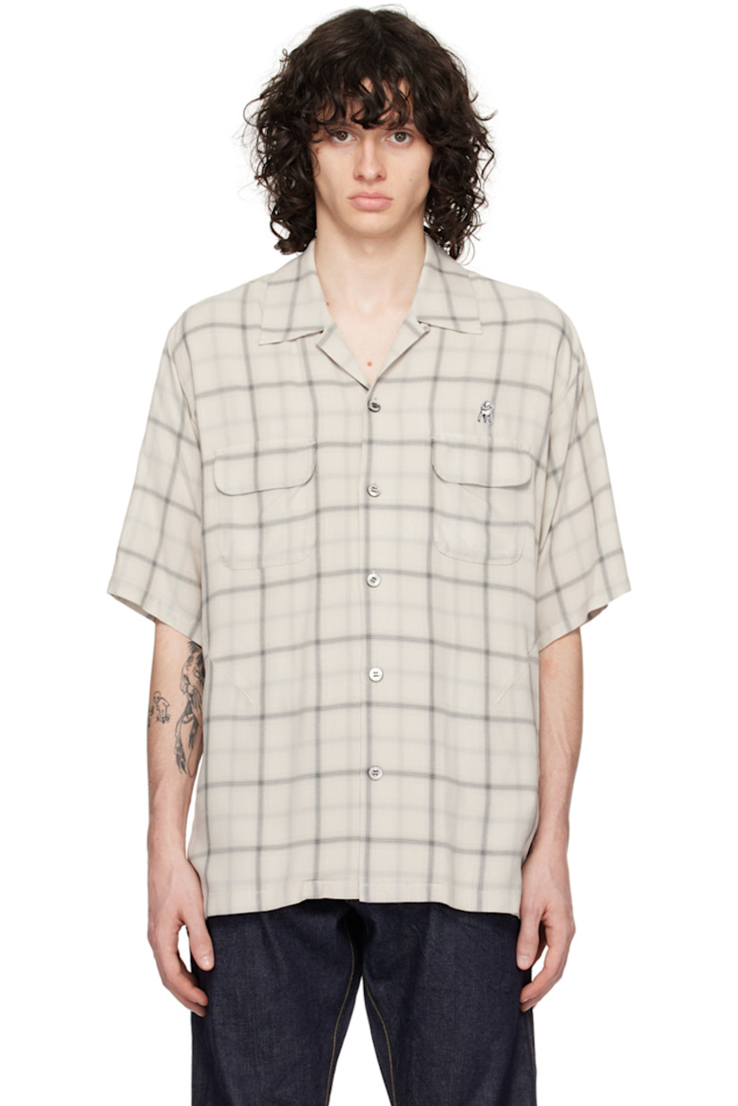 Rayon twill shirt. Check pattern throughout. 

· Open spread collar
· Button closure
· Logo appliqué at chest 
· Flap pockets and welt pocket
· Darts at front
· Locker loop at back collar
· Twin pleats at back yoke
· Partial poplin lining

Supplier color: Ivory check