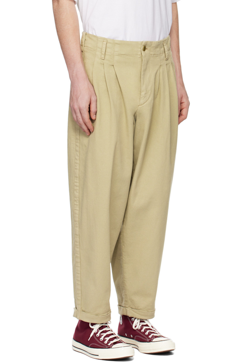 Loose-fit garment-dyed stretch cotton twill trousers. 

· Belt loops
· Three-pocket styling
· Zip-fly
· Pleated front 
· Rolled cuffs 
· Corozo hardware

Supplier color: Stone