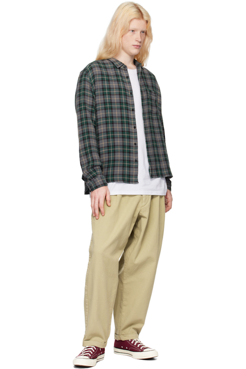 Loose-fit garment-dyed stretch cotton twill trousers. 

· Belt loops
· Three-pocket styling
· Zip-fly
· Pleated front 
· Rolled cuffs 
· Corozo hardware

Supplier color: Stone