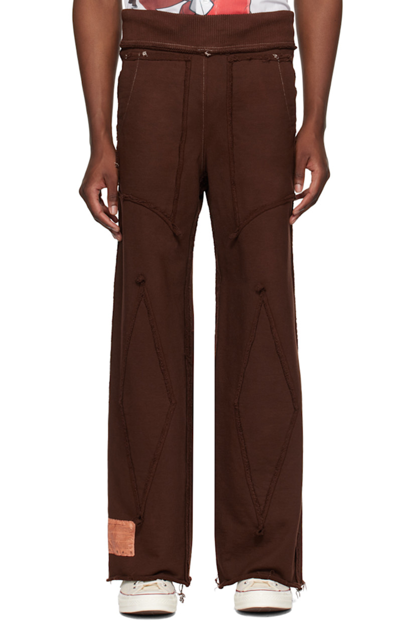 Garment-dyed French terry sweatpants. Exposed seams and frayed edges throughout.

· Paneled construction
· Concealed drawstring at rib knit waistband
· Four-pocket styling
· Logo patch at cuff
· Rolled edge at cuffs
· Contrast stitching in white

Available exclusively at SSENSE.

Supplier color: Brown