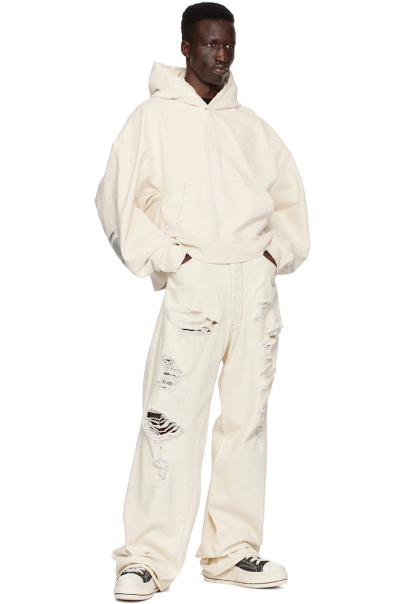 Non-stretch denim jeans. Distressing throughout. 

· Belt loops
· Five-pocket styling
· Button-fly
· Twisted inseams and outseams
· Locker loop at back waistband
· Logo patches at back
· Contrast stitching in yellow

Supplier color: Wash 5