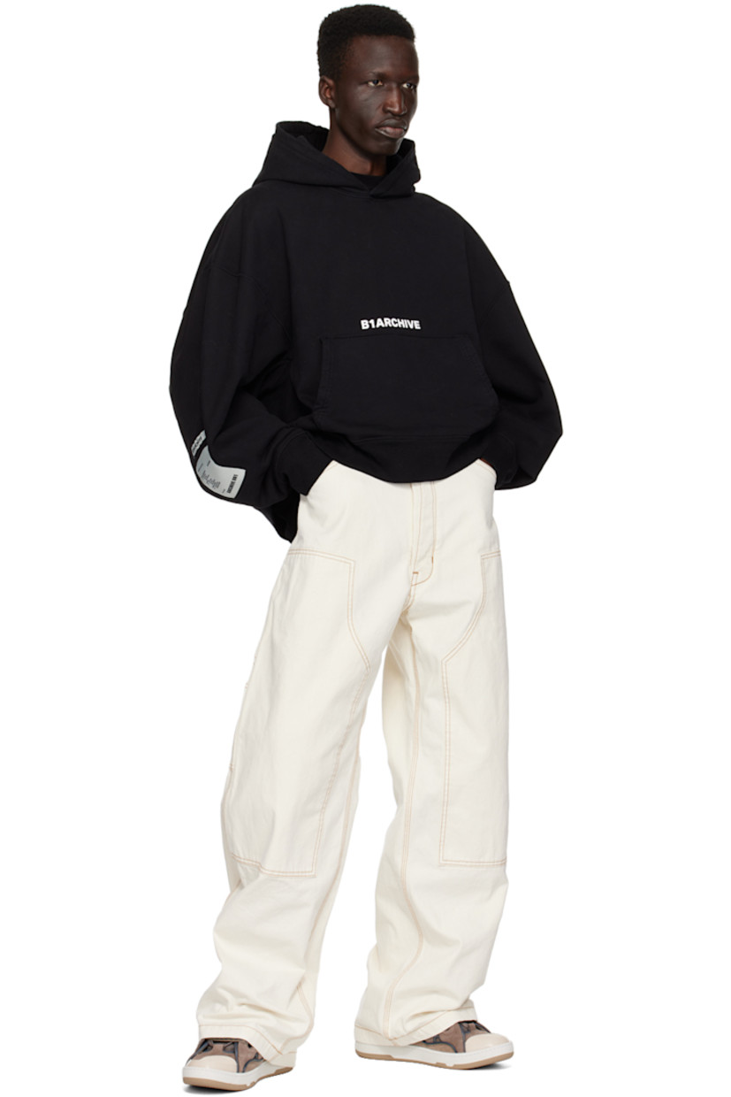 Wide-leg stone-washed cotton canvas trousers.

· Belt loops
· Five-pocket styling
· Button-fly
· Panels at front legs 
· Patch pockets and hammer loop at outseams
· Offset detailing at back waistband
· Locker loop at back 
· Logo patches at back leg
· Central seam at back legs
· Contrast stitching in brown

Supplier color: Ecru