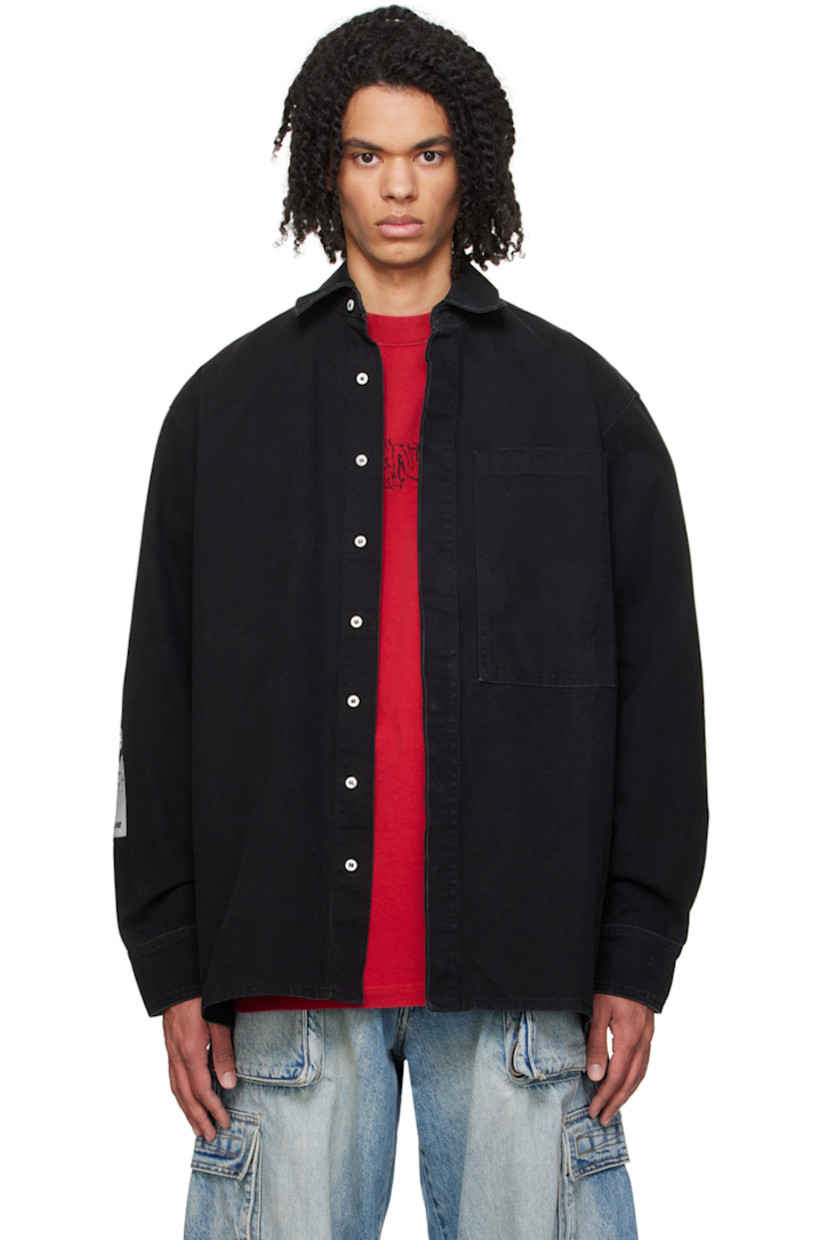 Cotton canvas shirt. Subtle fading throughout. 

· Spread collar
· Concealed button closure
· Patch pocket 
· Logo embroidered at hem 
· Logo patches at sleeve
· Single-button barrel cuffs 
· Locker loop at back collar
· Central seam and logo embroidered at back

Supplier color: Canvas black