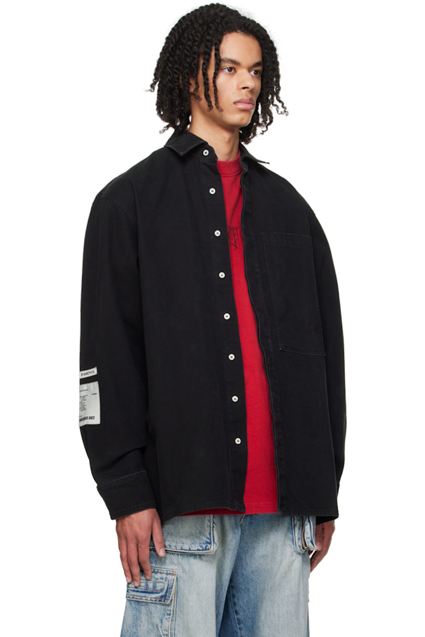 Cotton canvas shirt. Subtle fading throughout. 

· Spread collar
· Concealed button closure
· Patch pocket 
· Logo embroidered at hem 
· Logo patches at sleeve
· Single-button barrel cuffs 
· Locker loop at back collar
· Central seam and logo embroidered at back

Supplier color: Canvas black