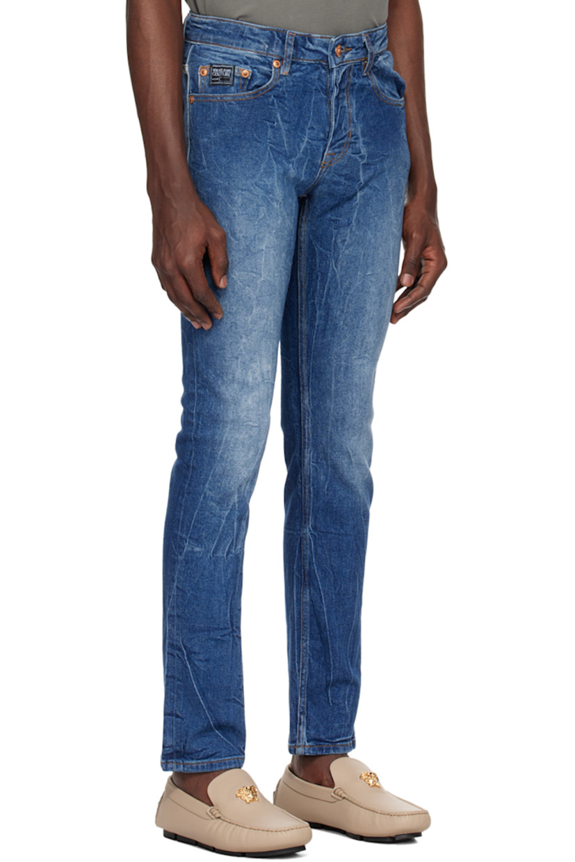 Crinkled stretch denim jeans. Fading throughout.

· Belt loops
· Five-pocket styling
· Zip-fly
· Logo patch at coin pocket
· Logo embroidered at back
· Logo-engraved copper-tone hardware
· Contrast stitching in tan

Supplier color: Indigo