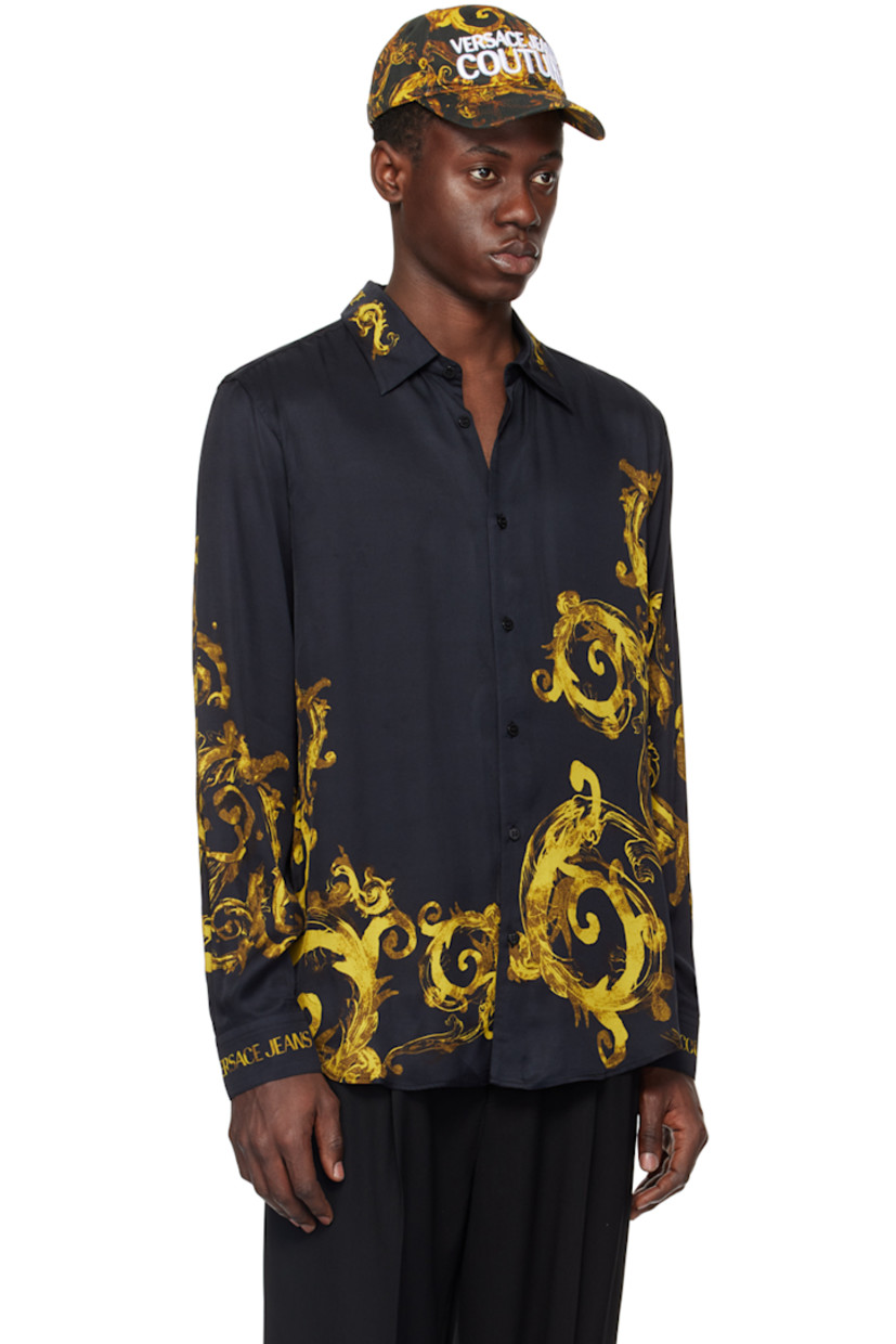 Viscose satin shirt. Logo and graphic pattern printed throughout.

· Spread collar
· Logo flag at button closure
· Shirttail hem
· Single-button barrel cuffs

Supplier color: Black/Gold