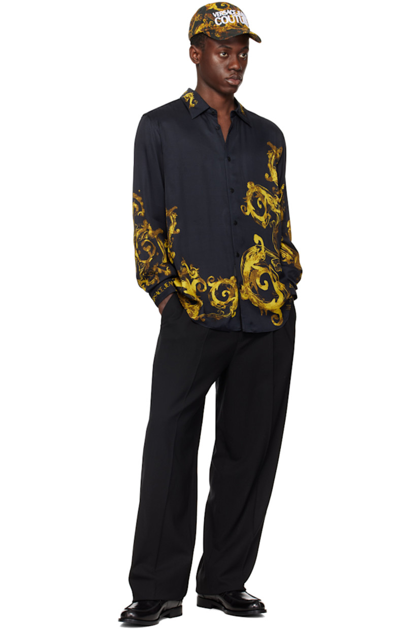 Viscose satin shirt. Logo and graphic pattern printed throughout.

· Spread collar
· Logo flag at button closure
· Shirttail hem
· Single-button barrel cuffs

Supplier color: Black/Gold