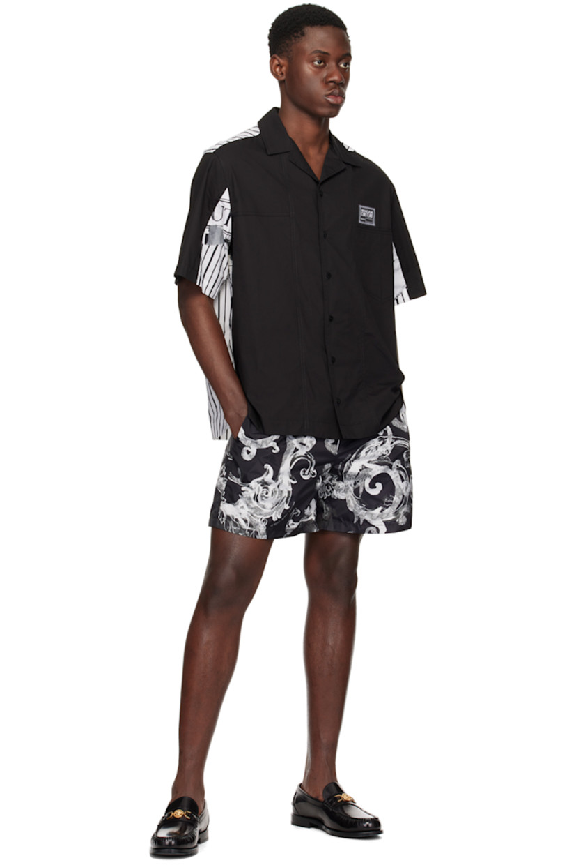 Cotton poplin shirt. 

· Paneled construction
· Open spread collar 
· Button closure
· Logo patch at patch pocket 
· Vented side seams 
· Logo graphic pattern and stripes printed at back

Supplier color: Black