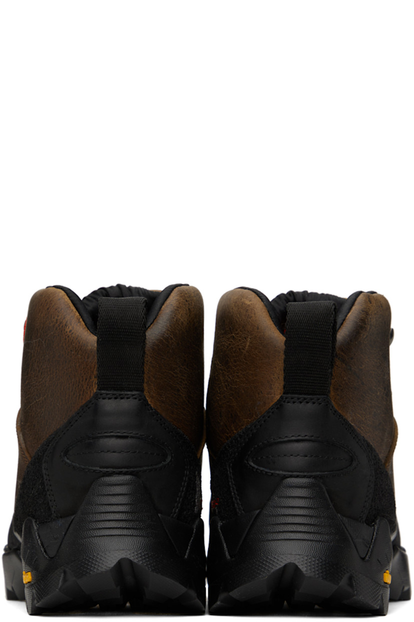 Ankle-high LWG-certified waxed kudu leather boots in brown.

· Rubberized trim throughout
· Logo printed at rubber cap toe
· Lace-up closure
· Logo embroidered at padded tongue
· Padded collar
· Logo embroidered at inner side
· Pull-loop at heel collar
· Jersey lining
· Treaded Vibram® Megagrip rubber sole

Supplier color: Noix