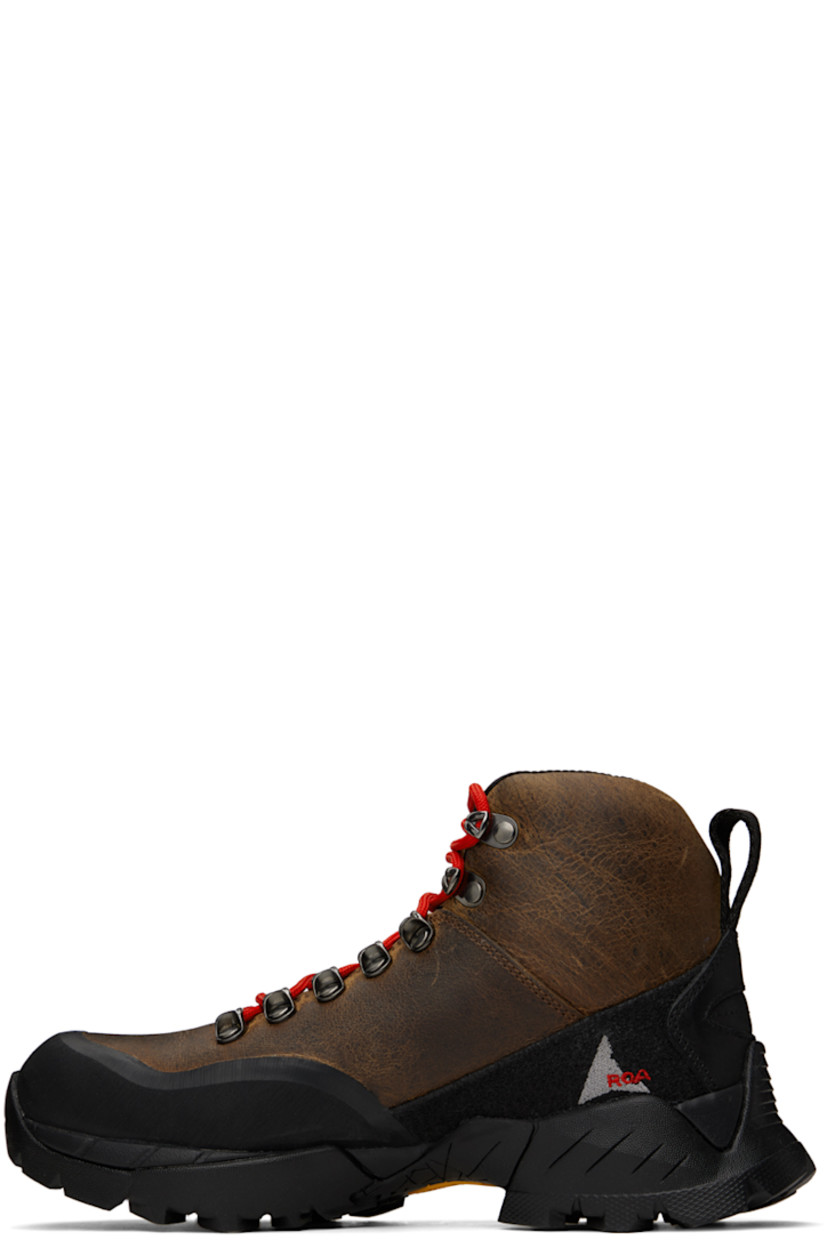 Ankle-high LWG-certified waxed kudu leather boots in brown.

· Rubberized trim throughout
· Logo printed at rubber cap toe
· Lace-up closure
· Logo embroidered at padded tongue
· Padded collar
· Logo embroidered at inner side
· Pull-loop at heel collar
· Jersey lining
· Treaded Vibram® Megagrip rubber sole

Supplier color: Noix