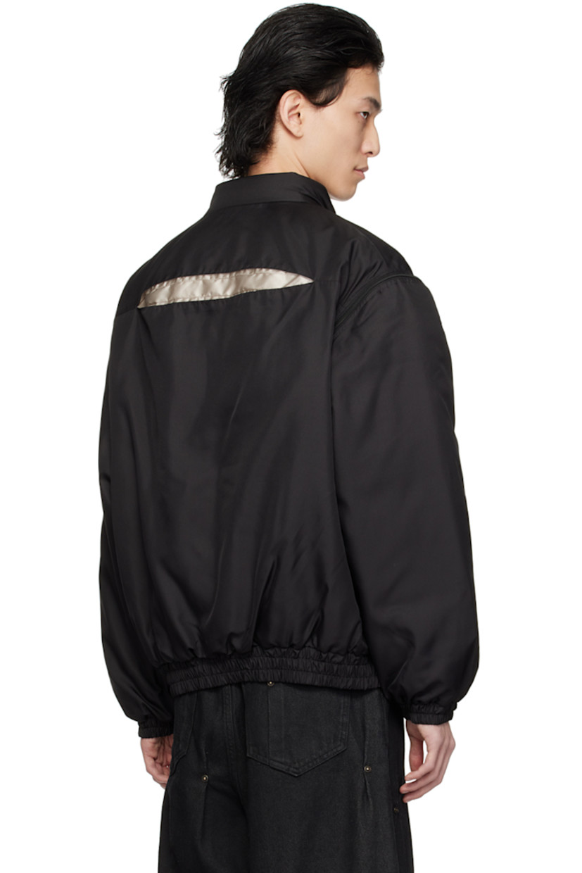 Padded polyester twill jacket.

· Stand collar
· Zip closure
· Hand-pleated detailing at front and back
· Welt pockets
· Elasticized hem and cuffs
· Detachable sleeves for alternate styling
· Zip pocket at interior
· Full taffeta lining

Supplier color: Black