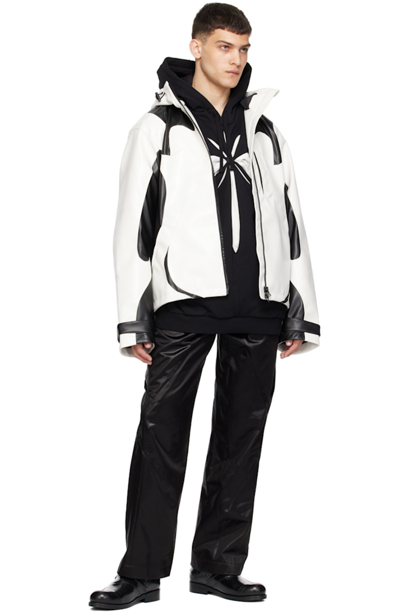 Grained faux-leather jacket. Smudging throughout.

· Paneled construction
· Bungee-style drawstring at hood and hem
· Stand collar
· Two-way zip closure
· Zip pockets
· Velcro tab at cuffs
· Graphic embroidered at back
· Zip pocket at interior
· Full satin lining

Supplier color: Black/Cannoli cream