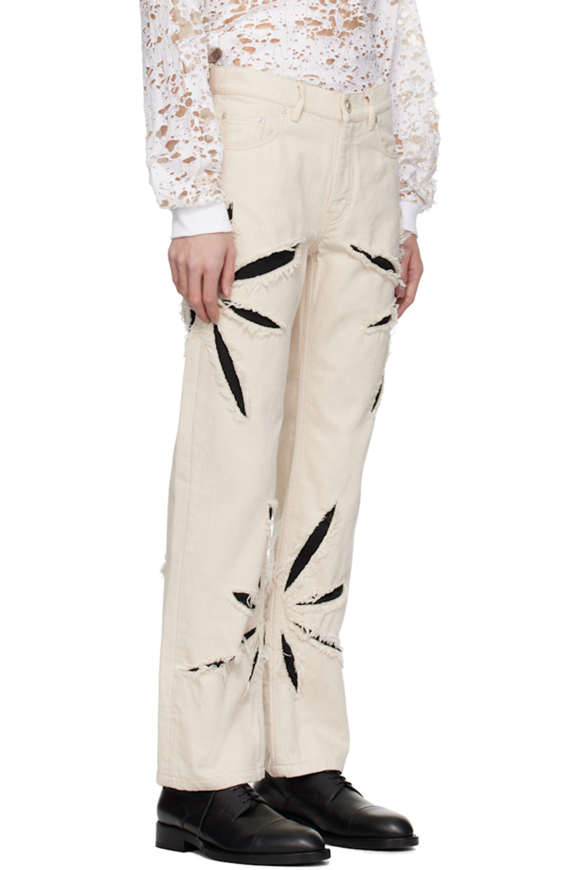 Straight-leg non-stretch denim jeans. 

· Belt loops
· Five-pocket styling
· Zip-fly
· Graphic cutouts and underlay at outseams
· Frayed edges at cutouts
· Logo patch at back waistband
· Full cotton herringbone lining
· Logo-engraved silver-tone hardware 

Supplier color: Cannoli cream/Black