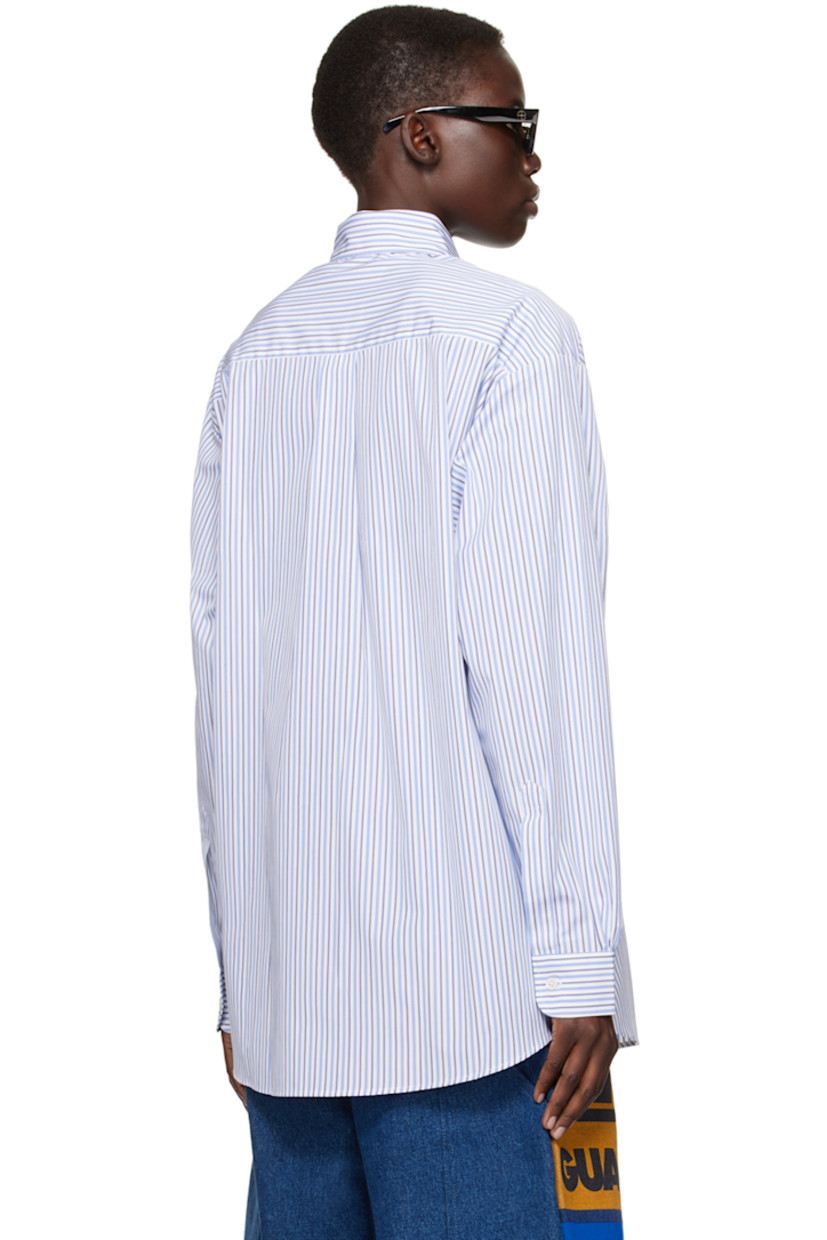 Deadstock cotton poplin shirt. Stripes throughout.

· Buttoned spread collar
· Button closure
· Patch pocket
· Logo graphic printed at front
· Shirttail hem
· Dropped shoulders
· Single-button barrel cuffs
· Box pleat at back yoke

Each item is unique. Please note that coloration and finishings may vary.

Supplier color: Blue