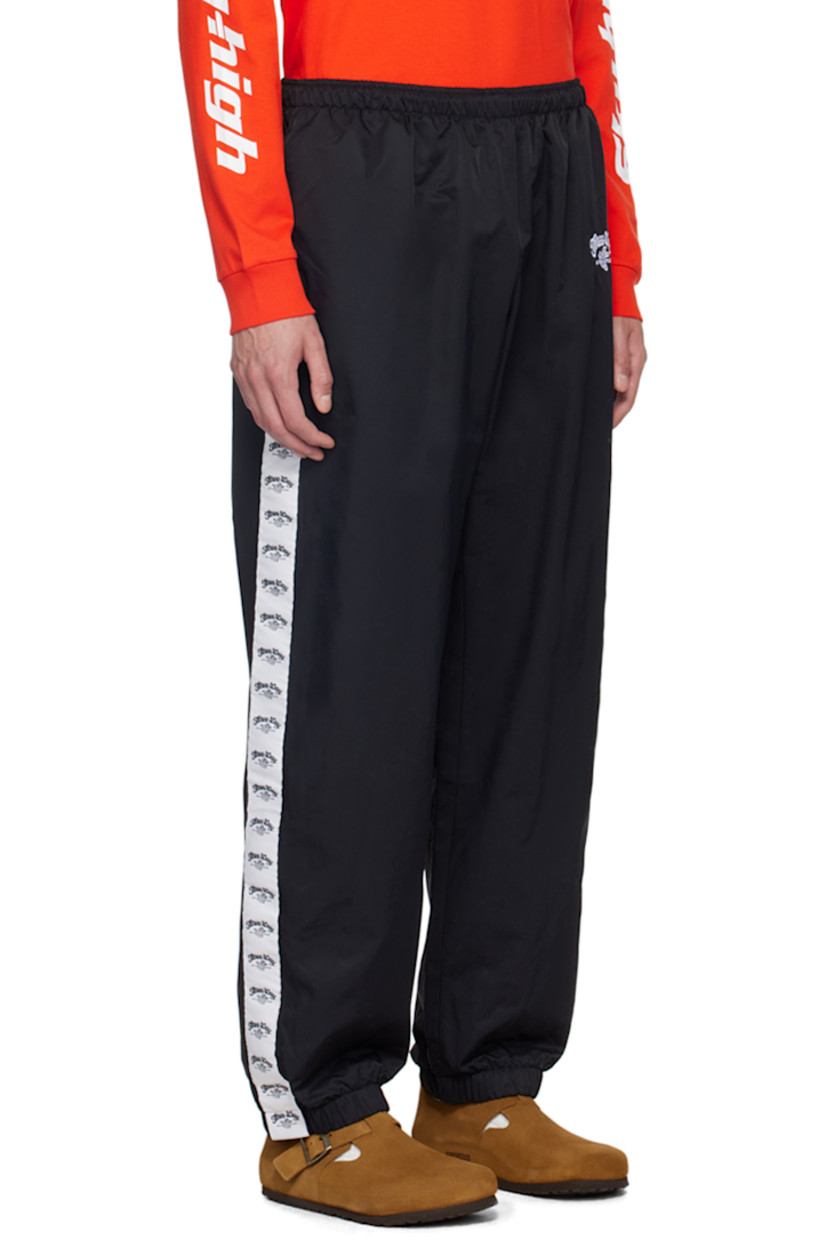 Straight-leg lightweight recycled nylon twill sweatpants.

· Concealed drawstring at elasticized waistband
· Two-pocket styling
· Text and logo embroidered at front
· Elasticized cuffs
· Logo-woven taffeta trim at outseams
· Full mesh lining

Supplier color: Black