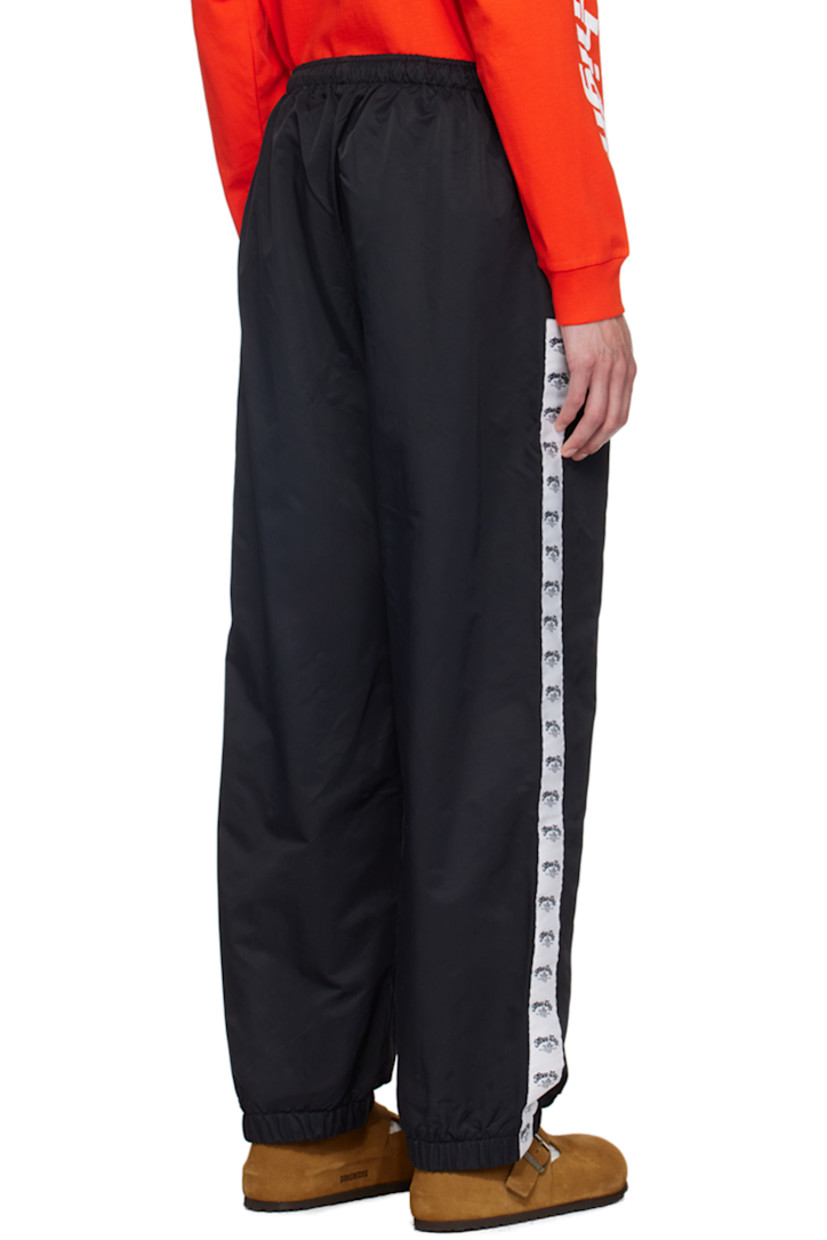 Straight-leg lightweight recycled nylon twill sweatpants.

· Concealed drawstring at elasticized waistband
· Two-pocket styling
· Text and logo embroidered at front
· Elasticized cuffs
· Logo-woven taffeta trim at outseams
· Full mesh lining

Supplier color: Black