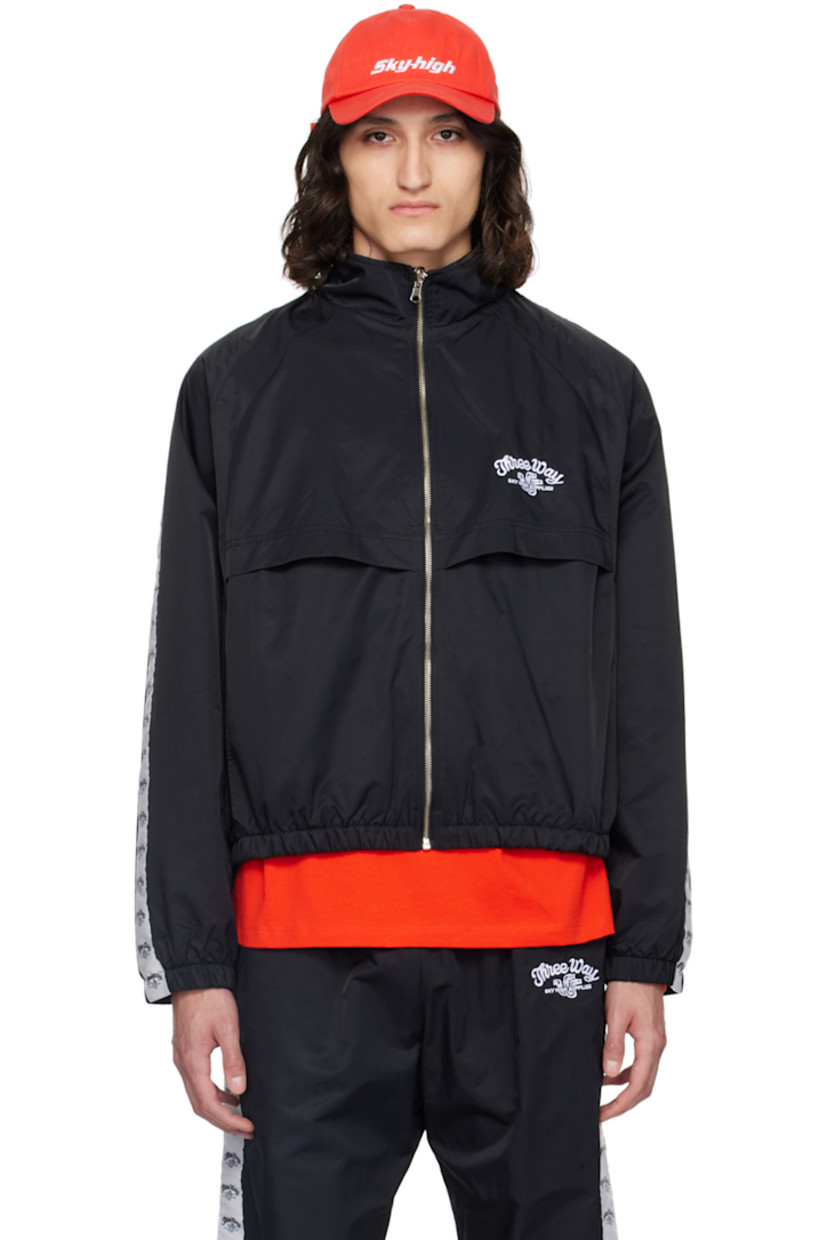 Lightweight recycled nylon twill track jacket.

· Stand collar
· Zip closure
· Text and logo embroidered at chest
· Flap and seam pockets
· Elasticized hem and cuffs
· Logo-woven taffeta trim at raglan sleeves
· Text and logo printed at back storm flap
· Full mesh lining

Supplier color: Black