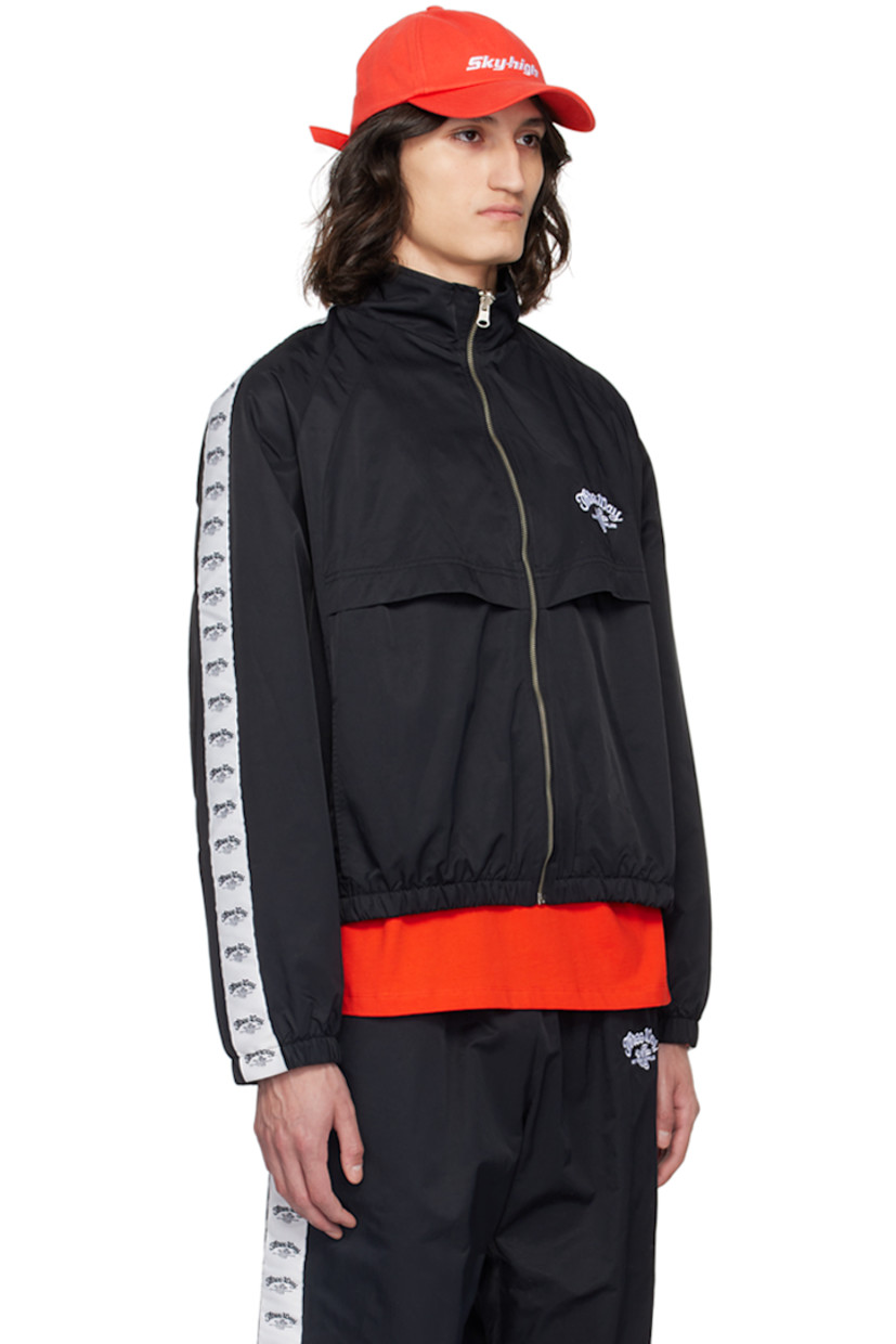 Lightweight recycled nylon twill track jacket.

· Stand collar
· Zip closure
· Text and logo embroidered at chest
· Flap and seam pockets
· Elasticized hem and cuffs
· Logo-woven taffeta trim at raglan sleeves
· Text and logo printed at back storm flap
· Full mesh lining

Supplier color: Black