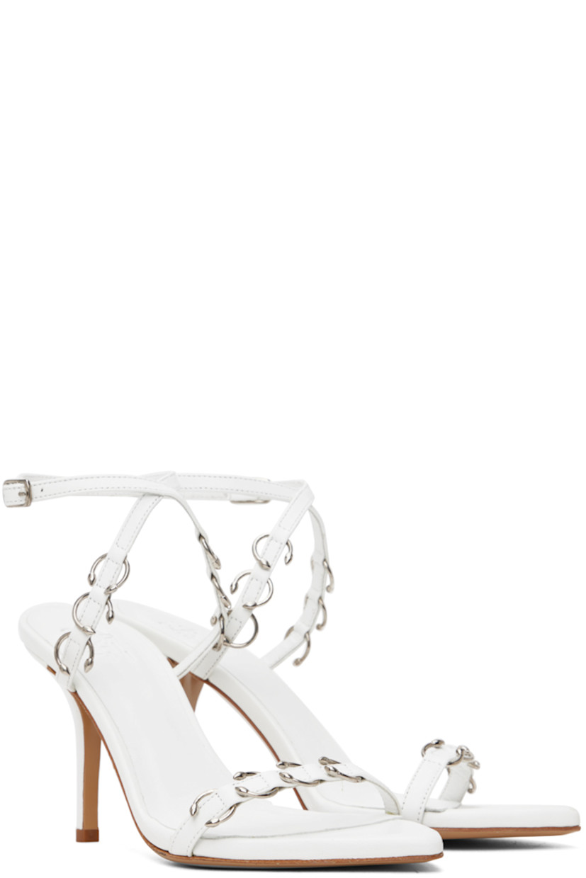 Buffed nappa leather heeled sandals in white.

· O-rings throughout
· Open pointed toe
· Strap at vamp
· Adjustable pin-buckle ankle strap
· Logo embossed at padded footbed
· Covered stiletto heel with rubber injection
· Leather sole
· Heel: H3.5"

Part of the Miaou x GIABORGHINI collaboration.

Supplier color: White