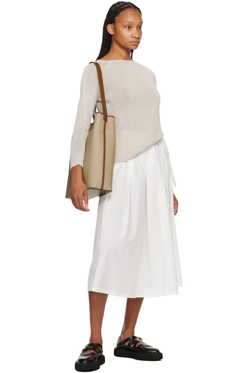 Canvas tote in beige.

· Buffed calfskin trim throughout
· Fixed shoulder strap
· Bumper studs at base
· Magnetic closure
· Laptop compartment at interior
· Grained faux-leather lining
· H14.5" x W13.25" x D4.25"

Supplier color: Canvas