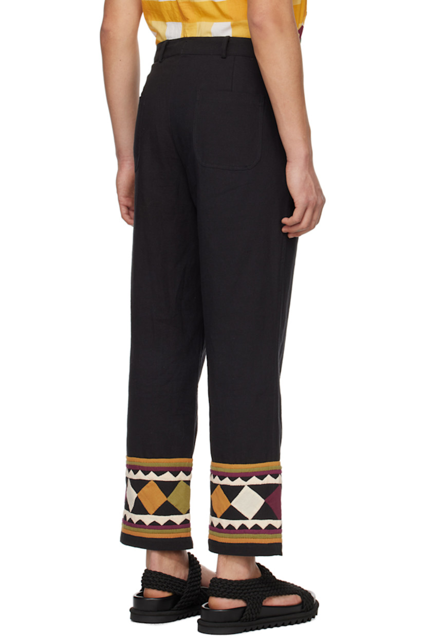 Handcrafted plain-woven cotton trousers.

· Belt loops
· Four-pocket styling
· Zip-fly
· Graphic appliqués and stripes at cuffs

Supplier color: Black