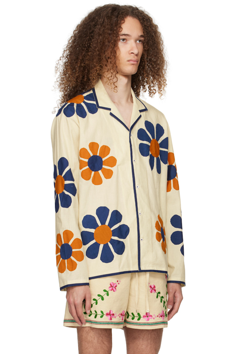 Handcrafted cotton broadcloth shirt. Floral appliqués and piping throughout.  

· Open spread collar
· Button closure

Supplier color: Off-white