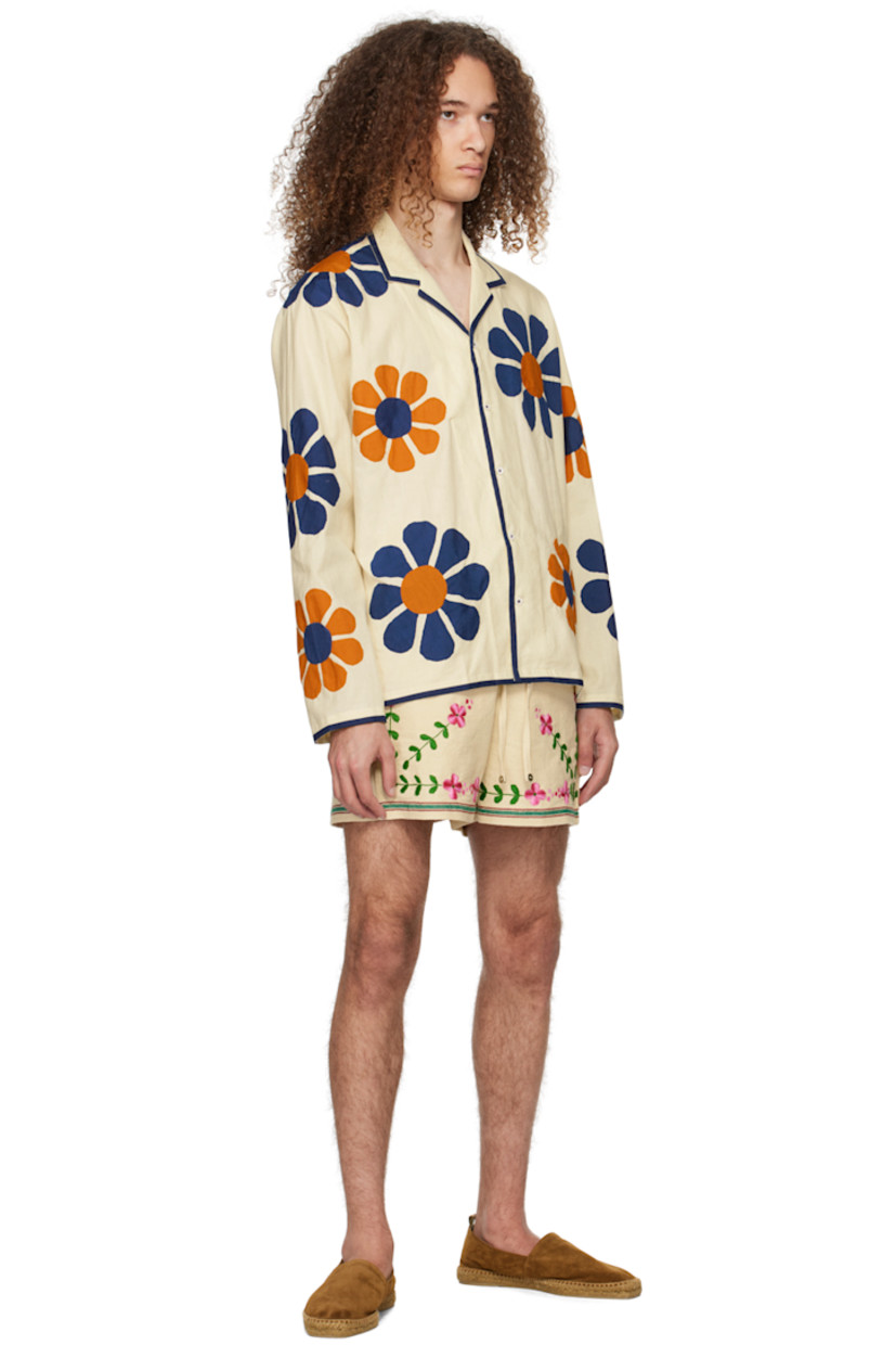 Handcrafted cotton broadcloth shirt. Floral appliqués and piping throughout.  

· Open spread collar
· Button closure

Supplier color: Off-white