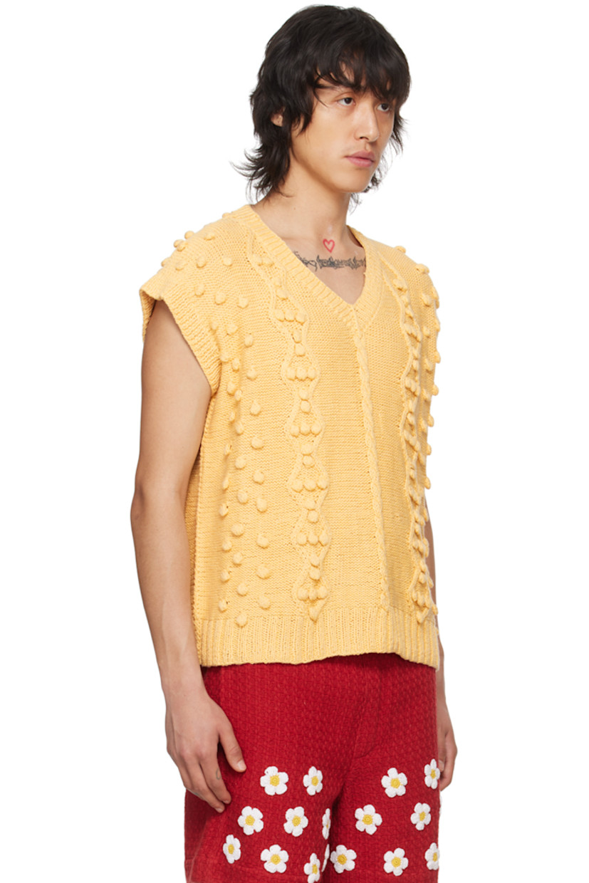 Handcrafted cable knit cotton vest. 

· Polka dot appliqué throughout
· Rib knit V-neck, hem, and armscyes

Supplier color: Beige