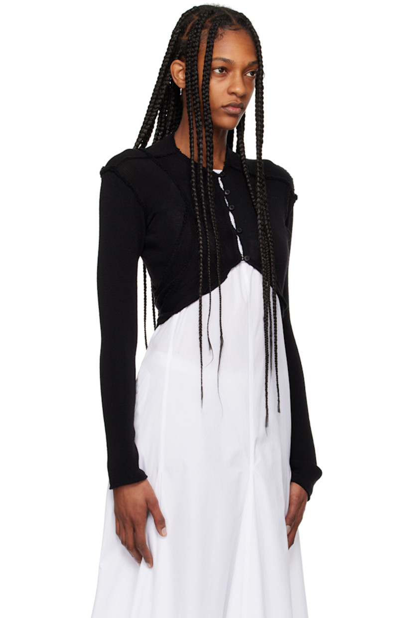 Knit merino wool bolero-style cardigan. Inverted seams throughout. 

· Paneled construction
· Crewneck
· Button closure 

Supplier color: Black