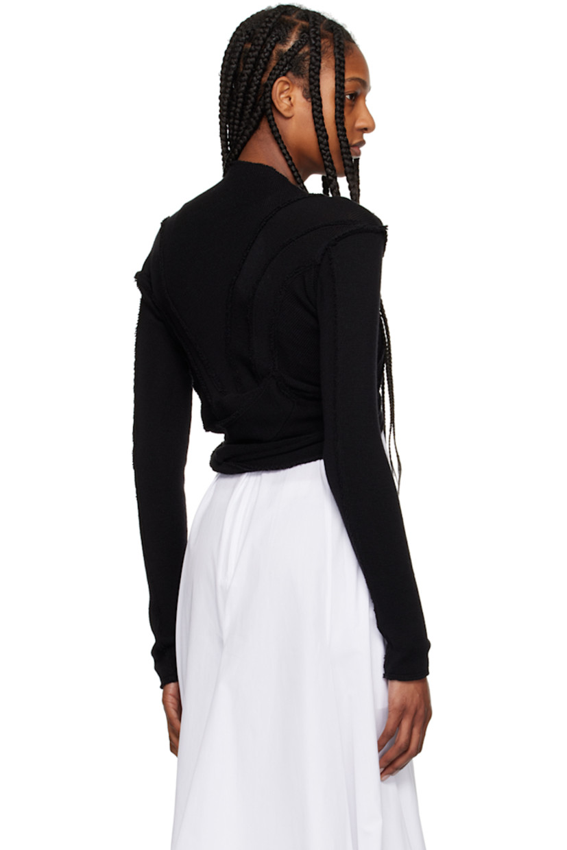 Knit merino wool bolero-style cardigan. Inverted seams throughout. 

· Paneled construction
· Crewneck
· Button closure 

Supplier color: Black