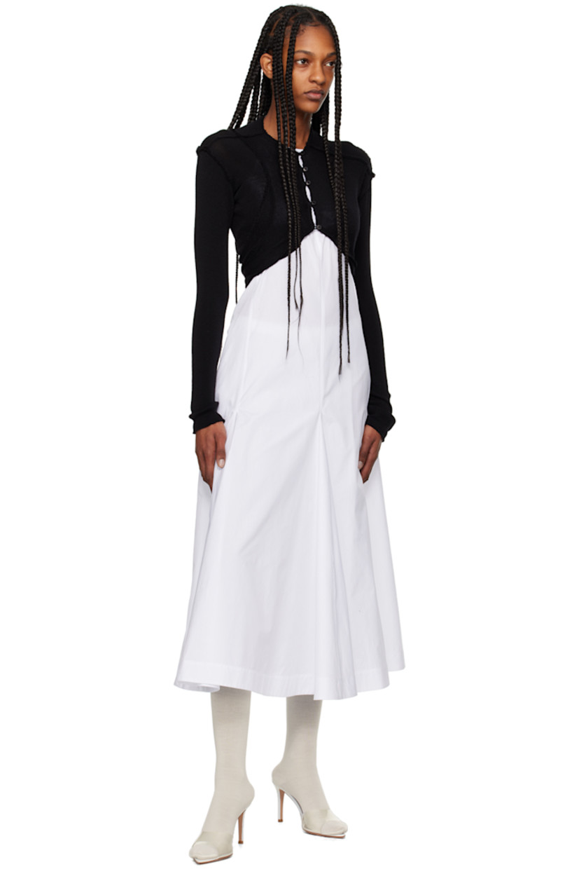 Knit merino wool bolero-style cardigan. Inverted seams throughout. 

· Paneled construction
· Crewneck
· Button closure 

Supplier color: Black