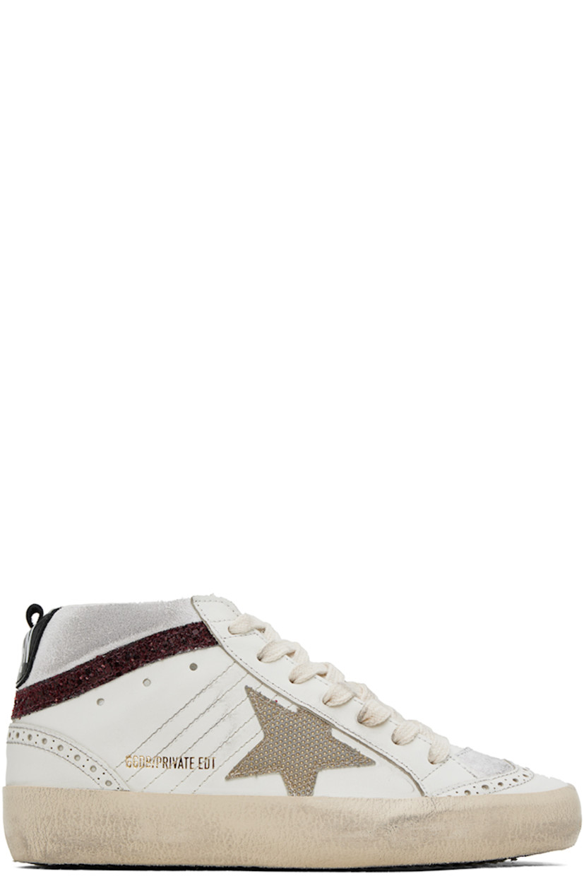 Handcrafted mid-top buffed leather and suede sneakers in white.

· Smudging and perforated detailing throughout
· Logo-printed lace-up closure
· Logo patch at tongue
· Padded collar
· Glittered detailing at sides and heel
· Signature star appliqué at outer side
· Gold-tone logo stamp at outer side
· Pull-loop at heel collar
· Logo printed at heel tab
· Suede and terrycloth lining
· Treaded rubber sole

Available exclusively at SSENSE.

Supplier color: Red/Gold