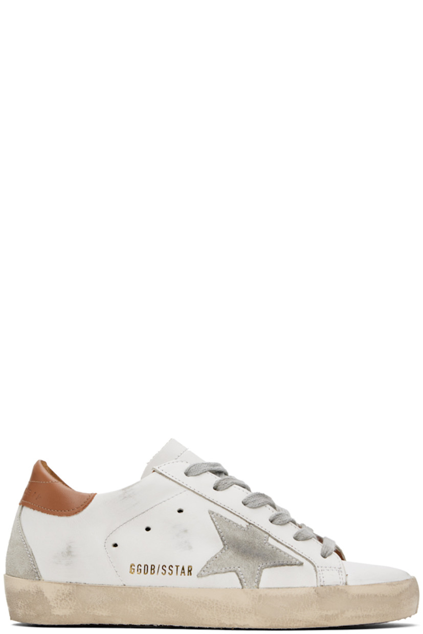 Handcrafted low-top buffed leather sneakers in white and brown. 

· Smudging throughout
· Lace-up closure
· Perforated detailing at tongue and sides
· Padded collar
· Signature star appliqué and text printed at outer side
· Logo embossed at heel tab
· Suede and terrycloth lining
· Treaded rubber sole

Available exclusively at SSENSE.

Supplier color: White/Brown
