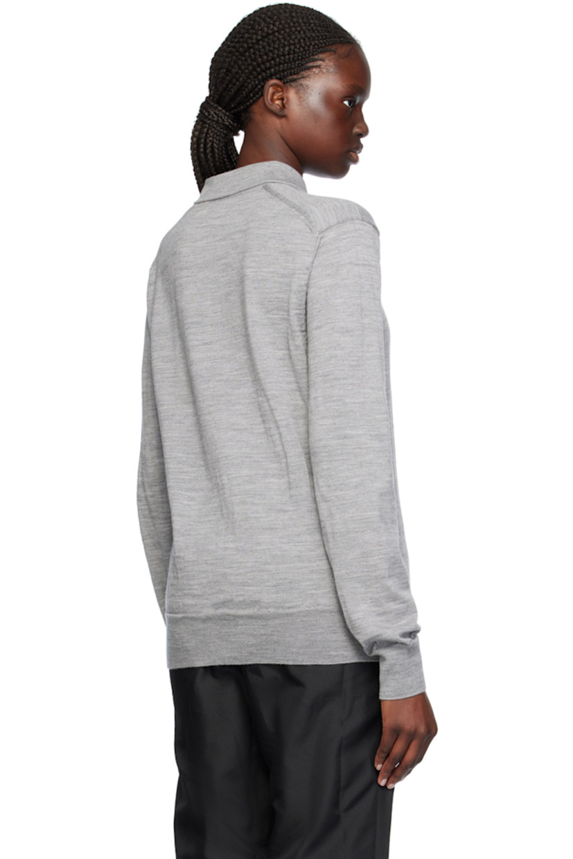 Knit wool polo.

· Rib knit spread collar, hem, and cuffs
· Two-button placket
· Intarsia text at chest

Supplier color: Gray